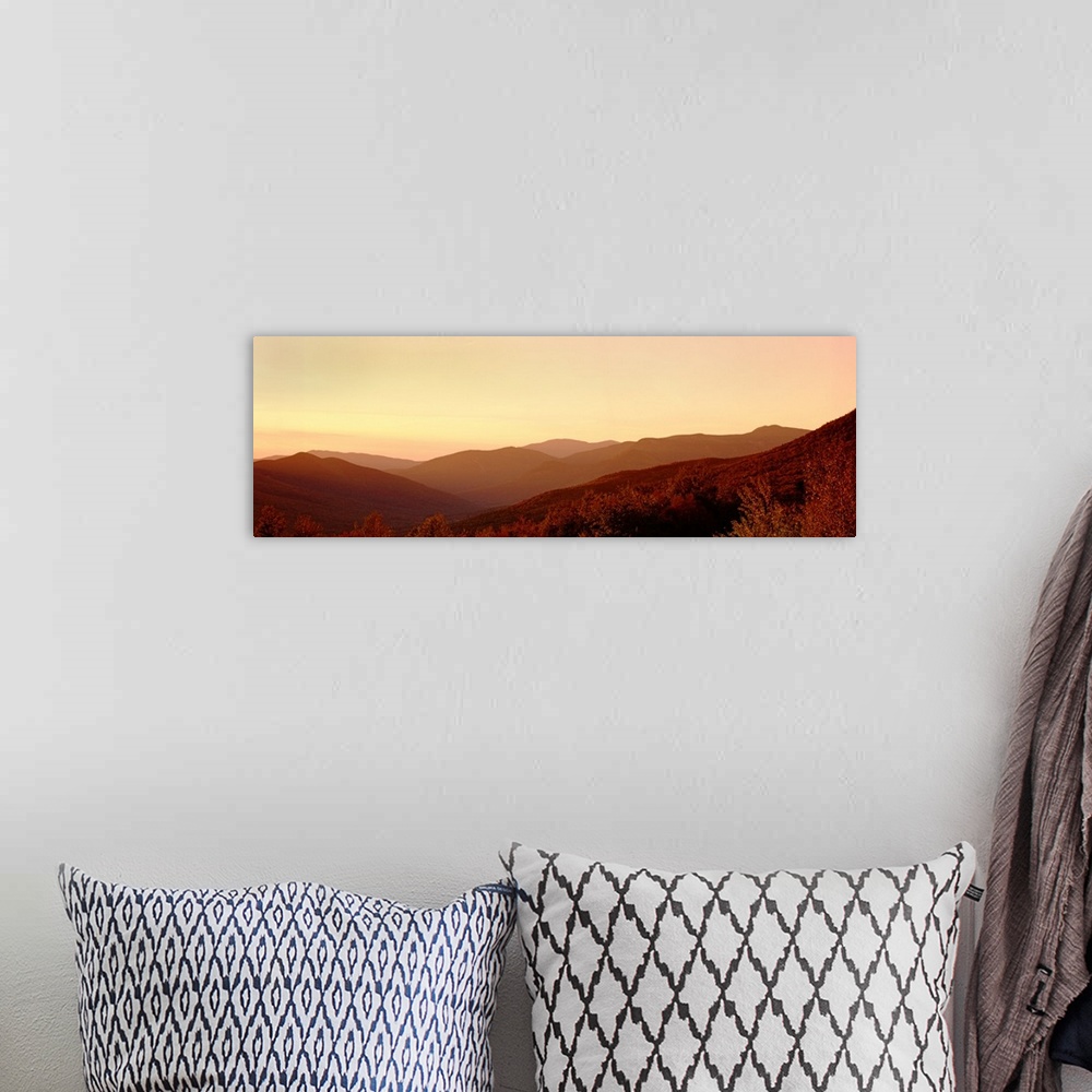 A bohemian room featuring Large panoramic image of rolling mountains in the foggy sunset.