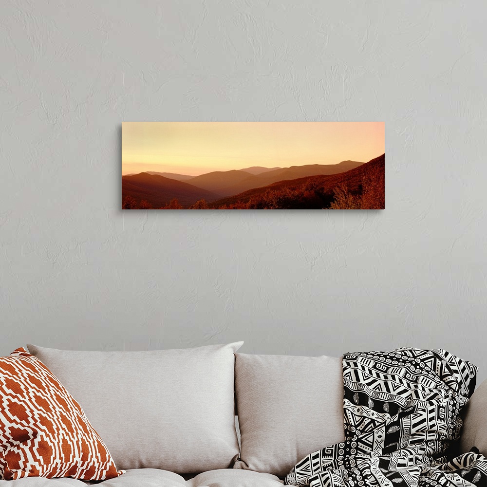 A bohemian room featuring Large panoramic image of rolling mountains in the foggy sunset.