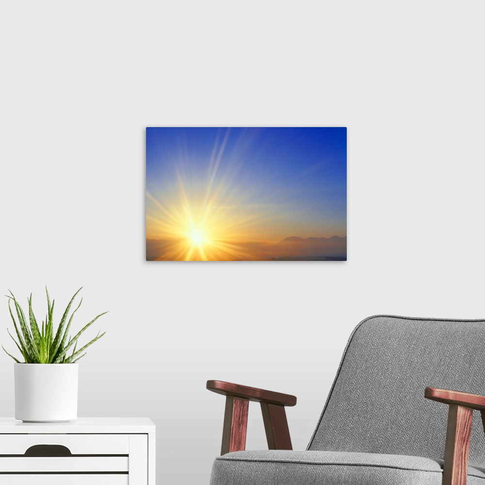 A modern room featuring Sunset over a mountain range
