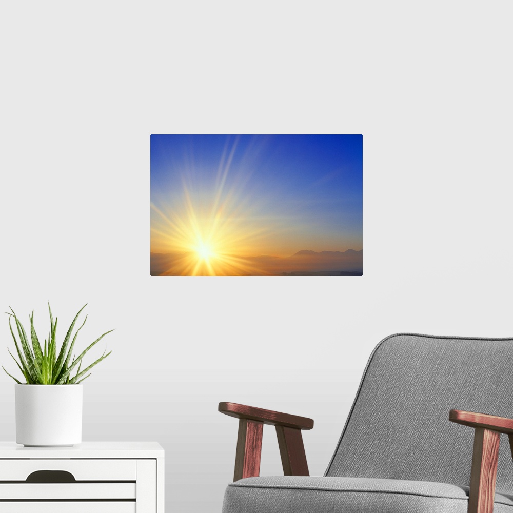 A modern room featuring Sunset over a mountain range