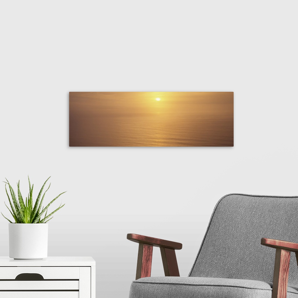 A modern room featuring Sunset over an ocean