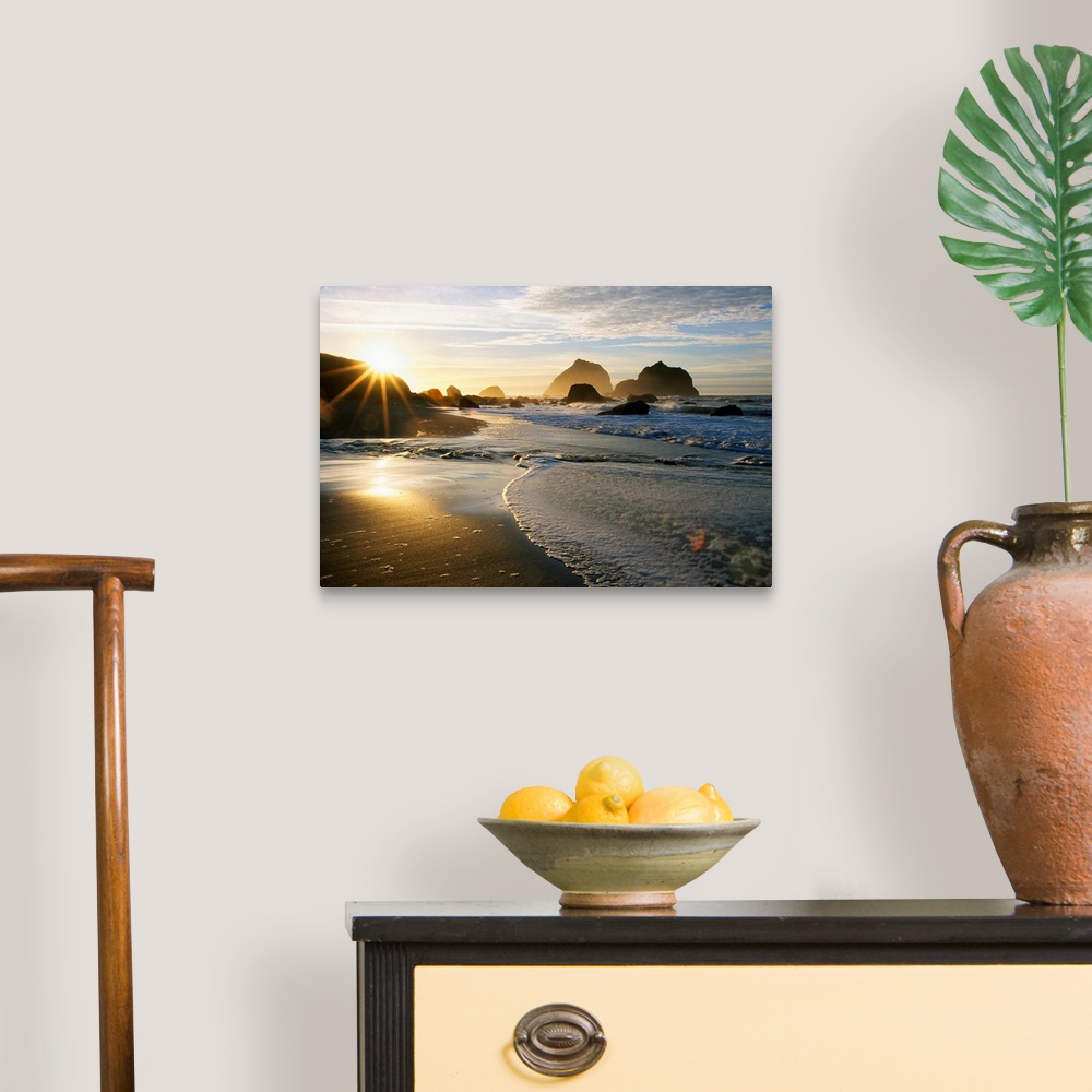 A traditional room featuring Panoramic photograph displaying a sunset over an ocean and sandy beach.  In the background you ca...