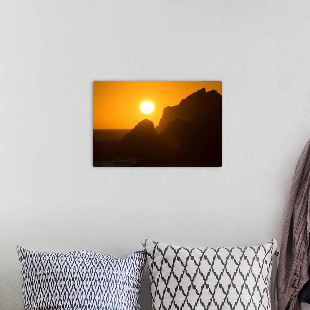 A bohemian room featuring Sunset Over Silhouetted Rocks