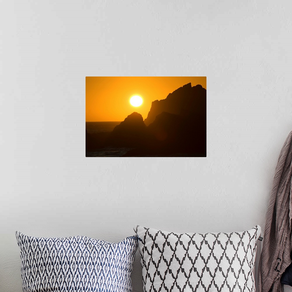 A bohemian room featuring Sunset Over Silhouetted Rocks