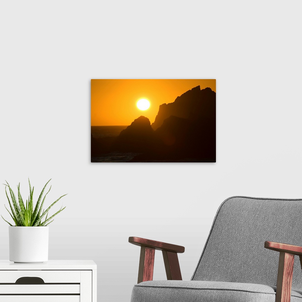 A modern room featuring Sunset Over Silhouetted Rocks