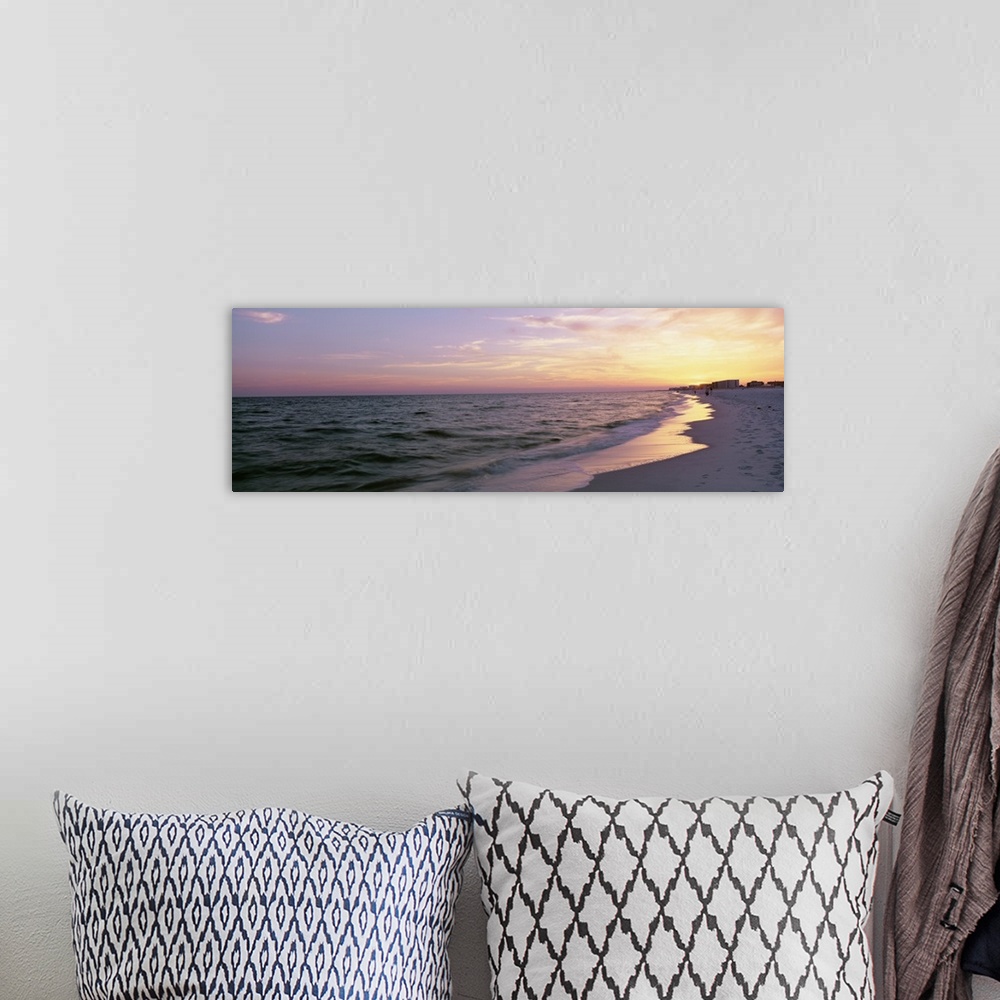 A bohemian room featuring Panoramic picture taken from a beach in Florida with a sun kissed sky over the ocean.