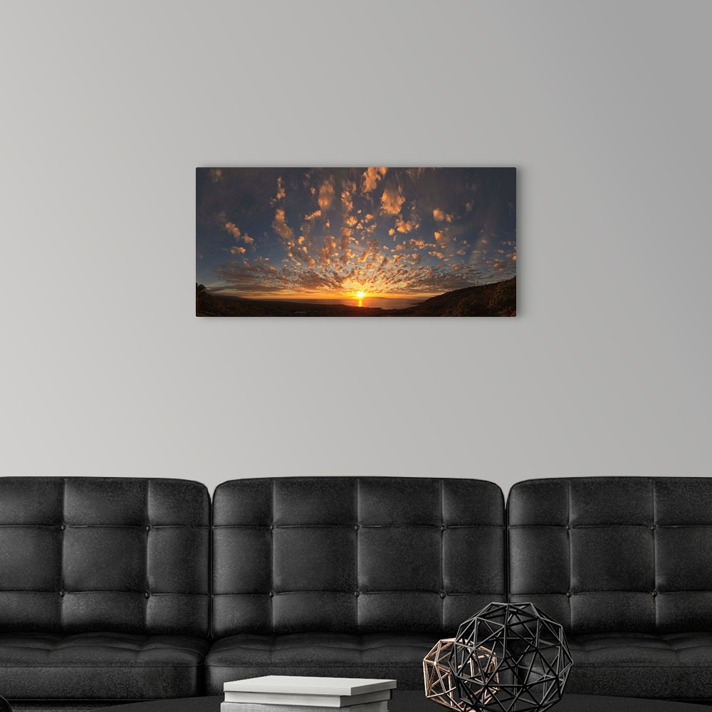 A modern room featuring Panoramic photograph taken from the coast of Kona, Hawaii of the sun setting over the Pacific Oce...