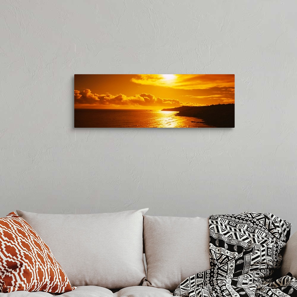 A bohemian room featuring This photograph is a panoramic seascape of the sun reflecting off the shallow beach water as it s...