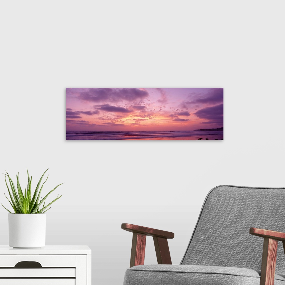 A modern room featuring Panoramic photograph of a pastel sunset over the Pacific Beach in San Diego, California, with swi...