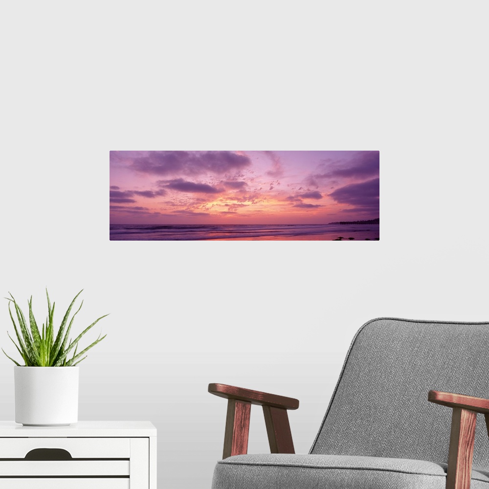 A modern room featuring Panoramic photograph of a pastel sunset over the Pacific Beach in San Diego, California, with swi...