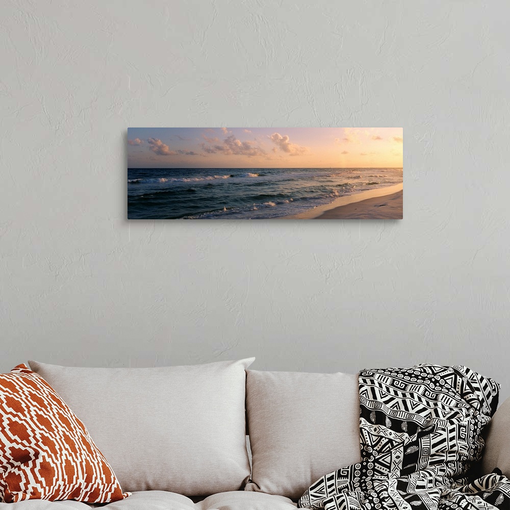 A bohemian room featuring Panoramic photograph showcases waves of the Atlantic Ocean making their way to the Florida shore ...
