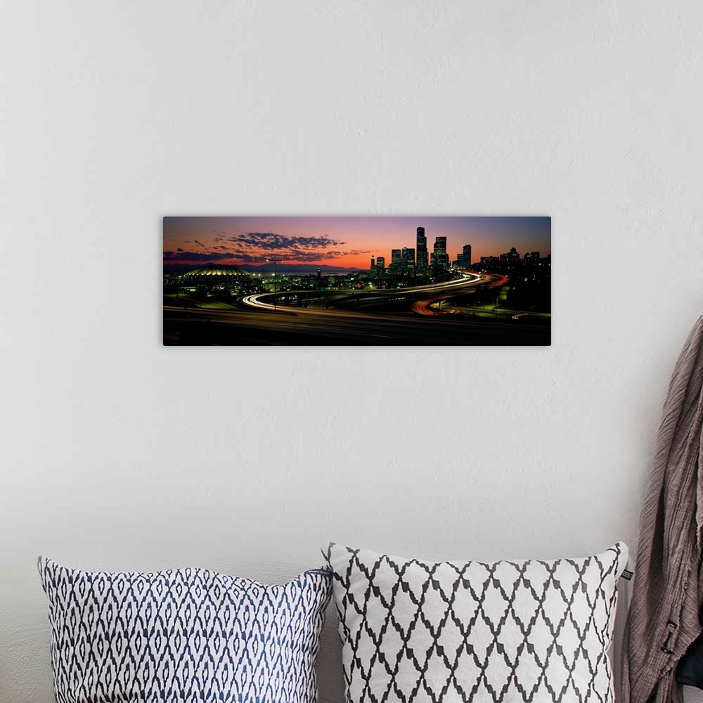A bohemian room featuring Panoramic photograph emphasizes the sun as it begins to set over the busy skyline of a city in th...