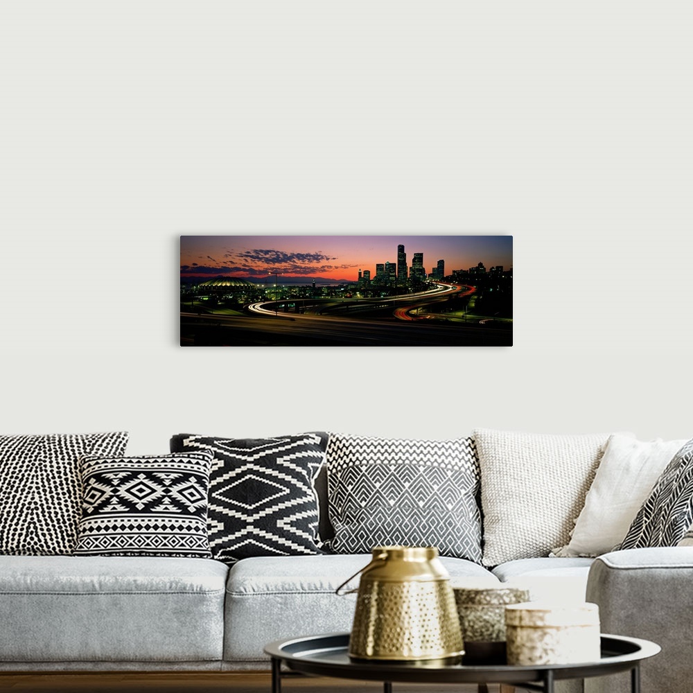 A bohemian room featuring Panoramic photograph emphasizes the sun as it begins to set over the busy skyline of a city in th...