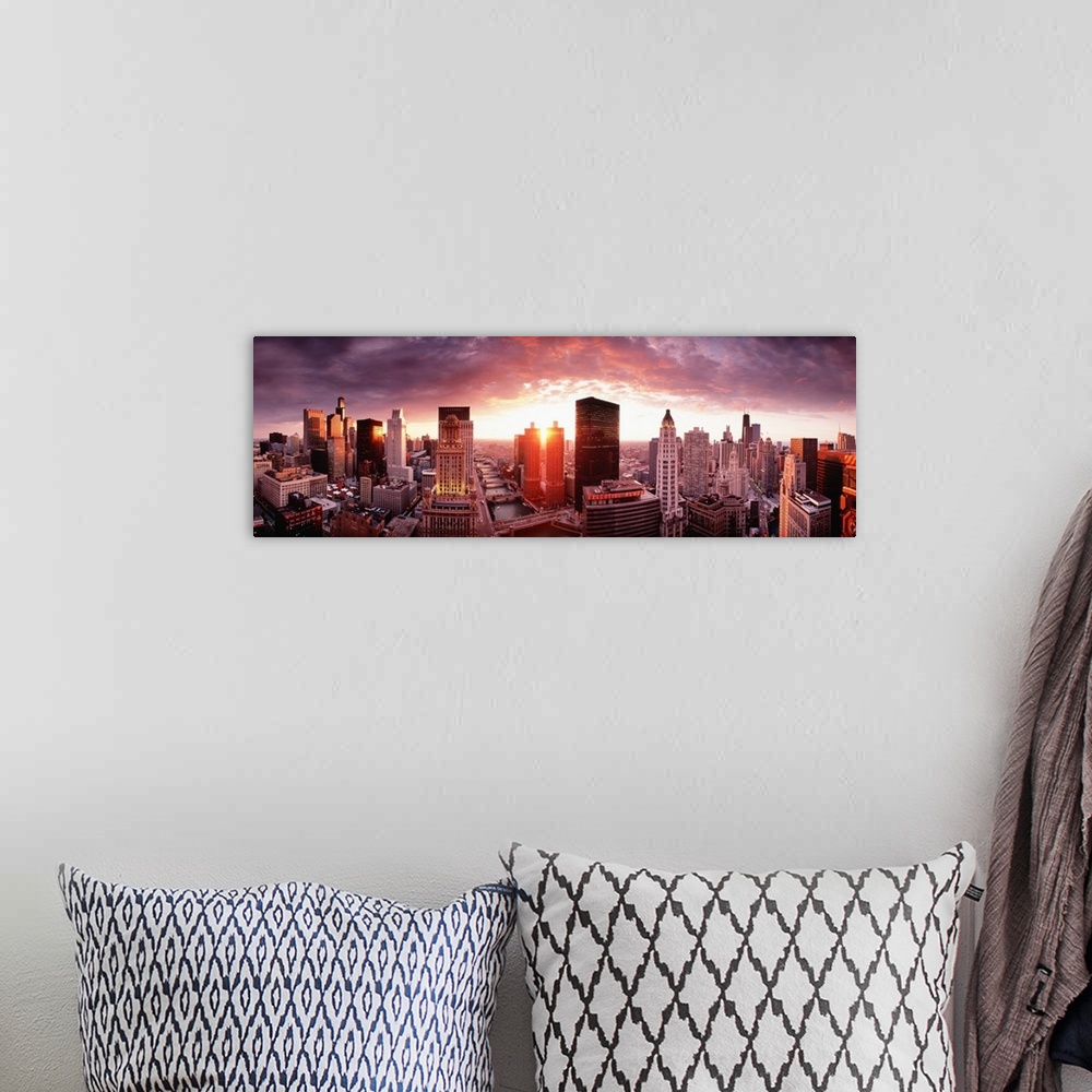 A bohemian room featuring This wall hanging is a panoramic photograph of the city skyline and the sun disappearing between ...