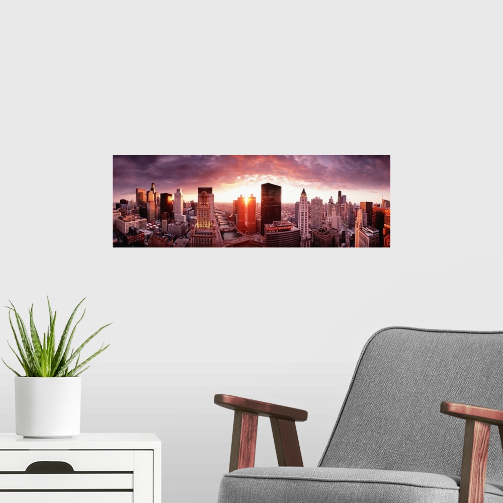 A modern room featuring This wall hanging is a panoramic photograph of the city skyline and the sun disappearing between ...