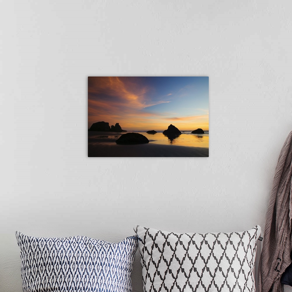 A bohemian room featuring Photograph of rocky shore at dusk.  There are huge rocks emerging from the sand and ripples of wa...