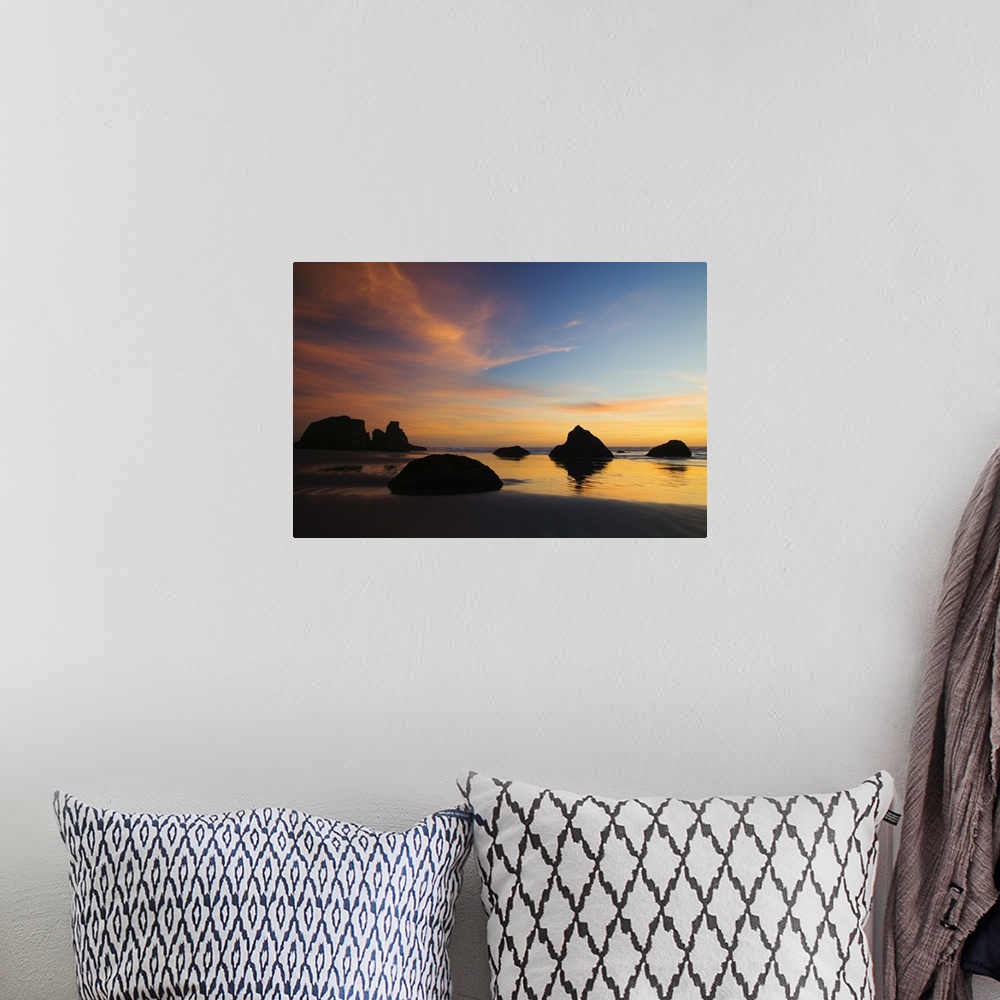 A bohemian room featuring Photograph of rocky shore at dusk.  There are huge rocks emerging from the sand and ripples of wa...