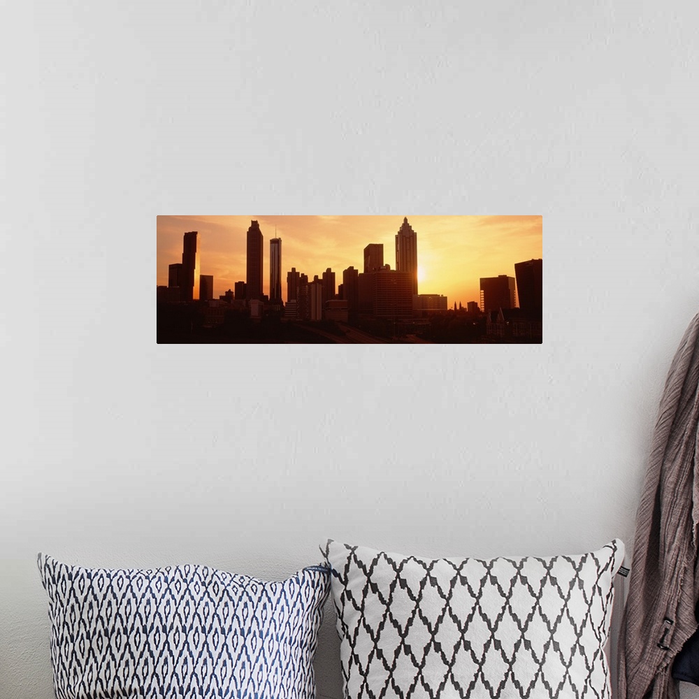 A bohemian room featuring Panoramic photograph displays the sun beginning to set over the skyline of a capital city in the ...
