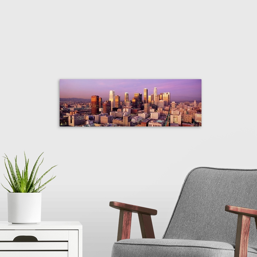 A modern room featuring Giant horizontal panoramic photograph of the city of Los Angeles, California (CA) as the sun begi...