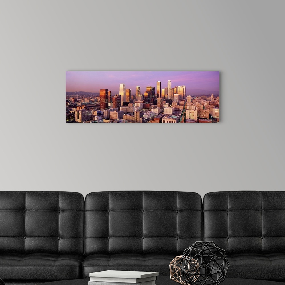 A modern room featuring Giant horizontal panoramic photograph of the city of Los Angeles, California (CA) as the sun begi...