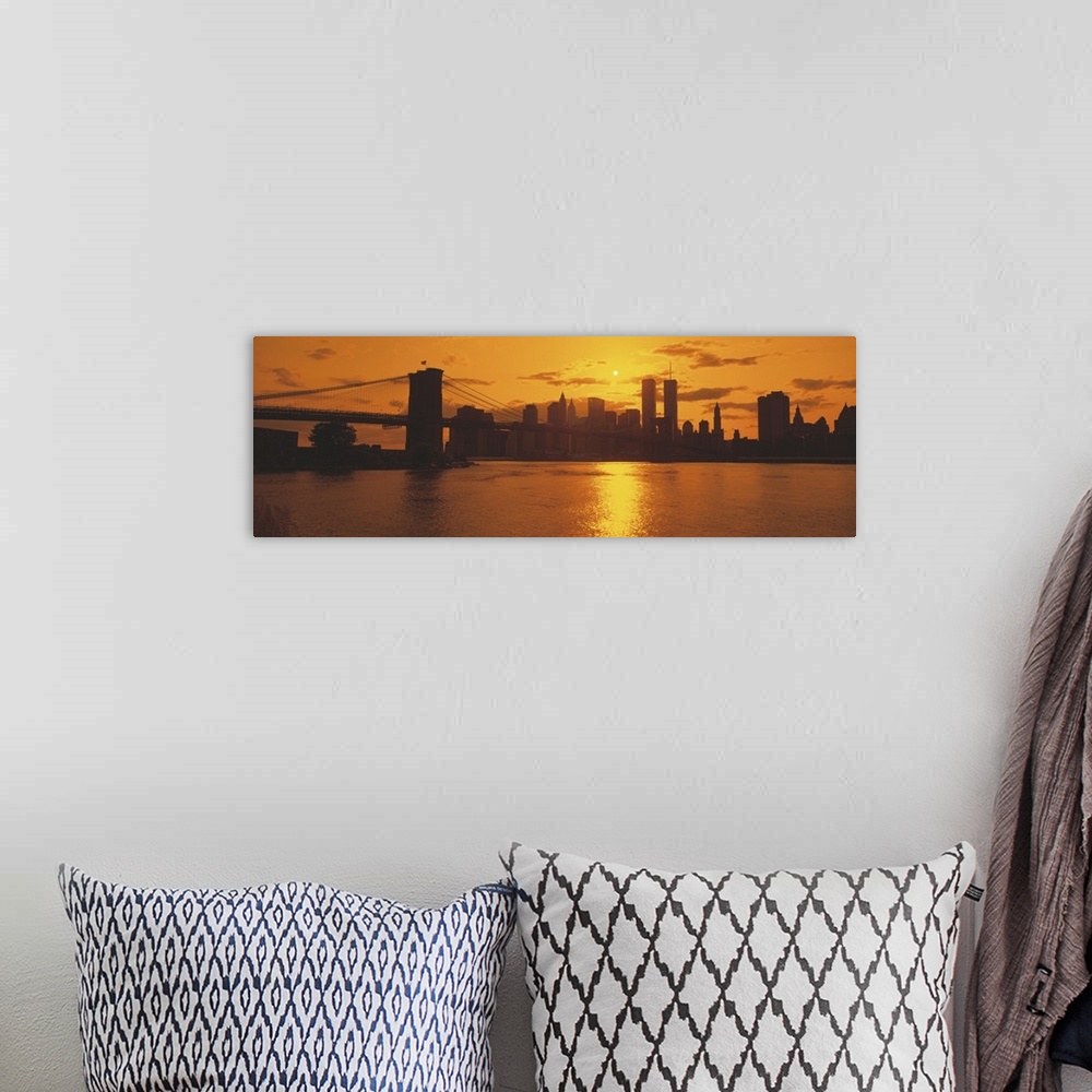 A bohemian room featuring This wall art for the home or office is a panoramic photograph of the Manhattan skyline silhouett...