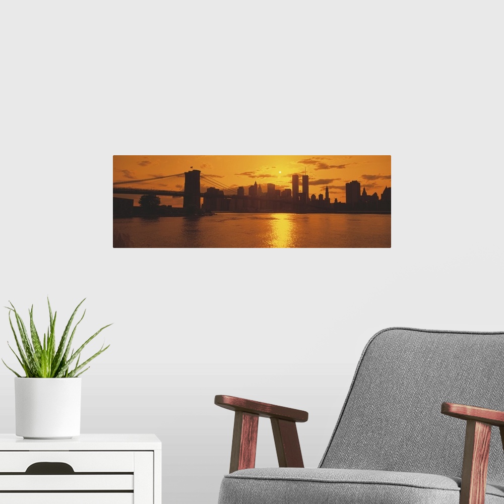 A modern room featuring This wall art for the home or office is a panoramic photograph of the Manhattan skyline silhouett...