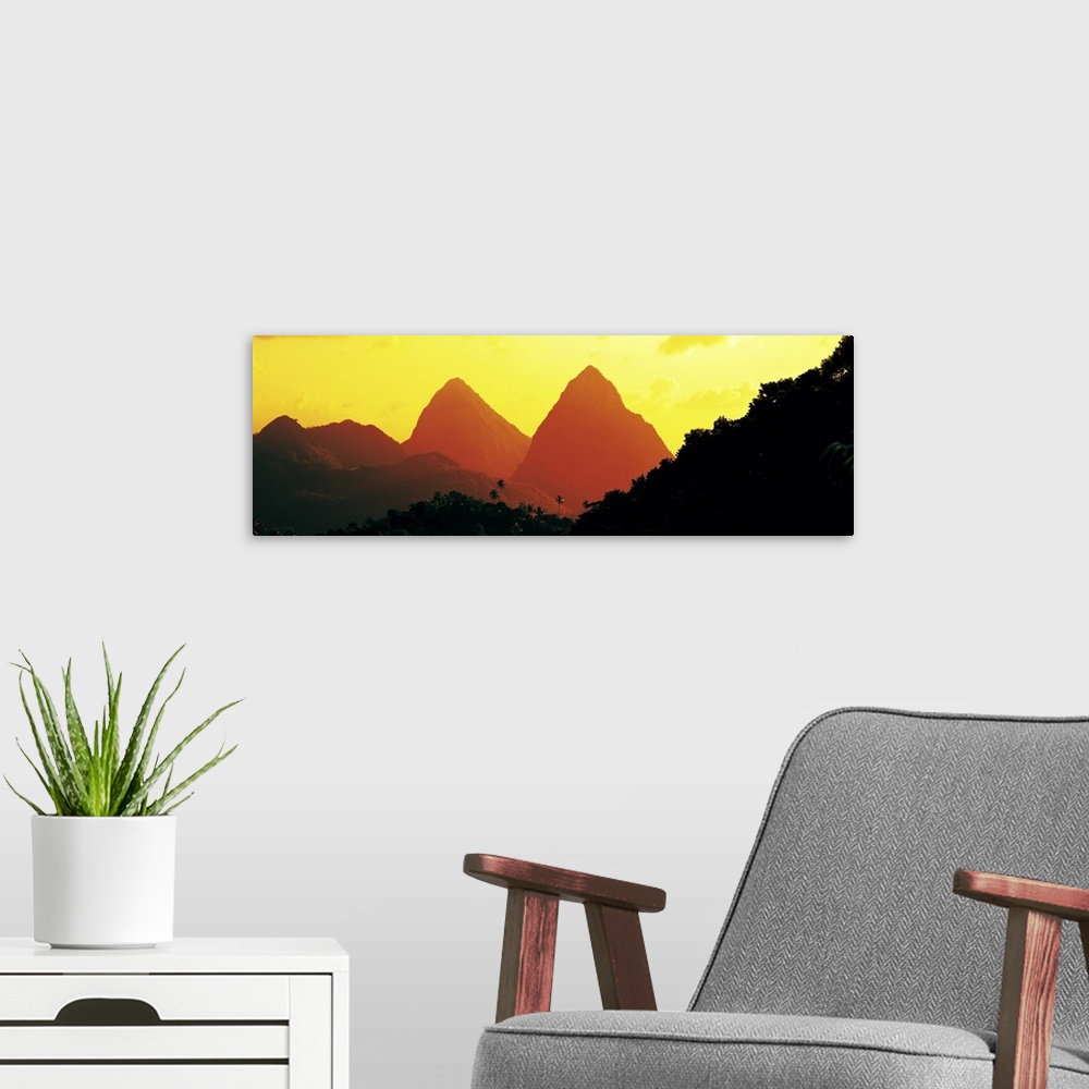 A modern room featuring Panoramic photograph of mountain silhouettes with forest tree tops in the foreground.