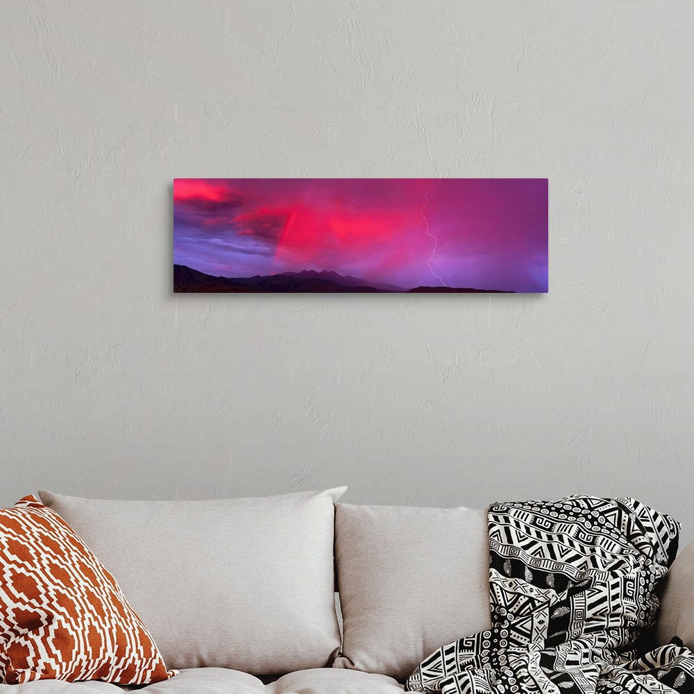 A bohemian room featuring This panoramic photograph is taken of a sunset sky that is highlighted with hot pink and a bolt o...