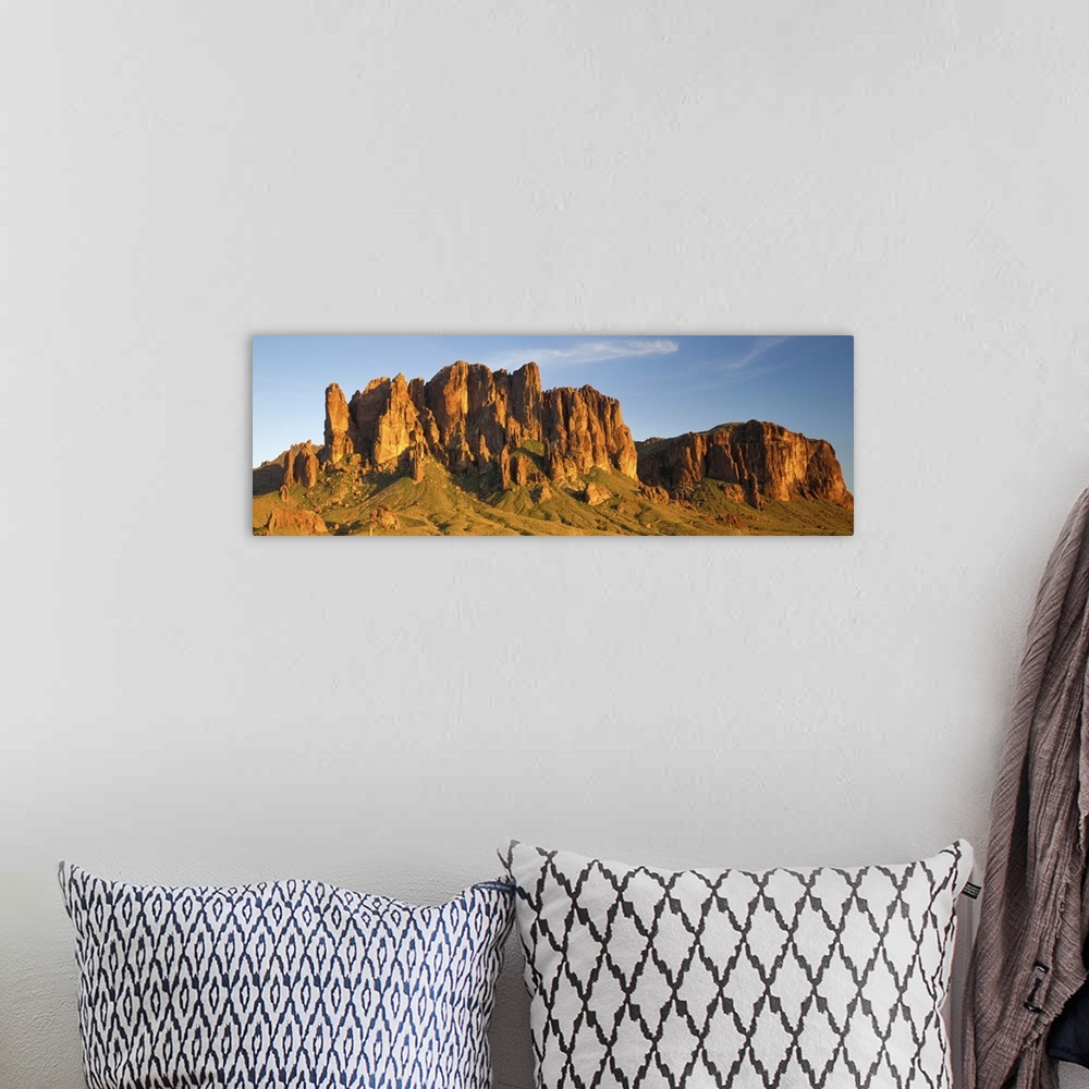 A bohemian room featuring Large Panoramic shot of desert mountains shooting up in the barren flats of Arizona.