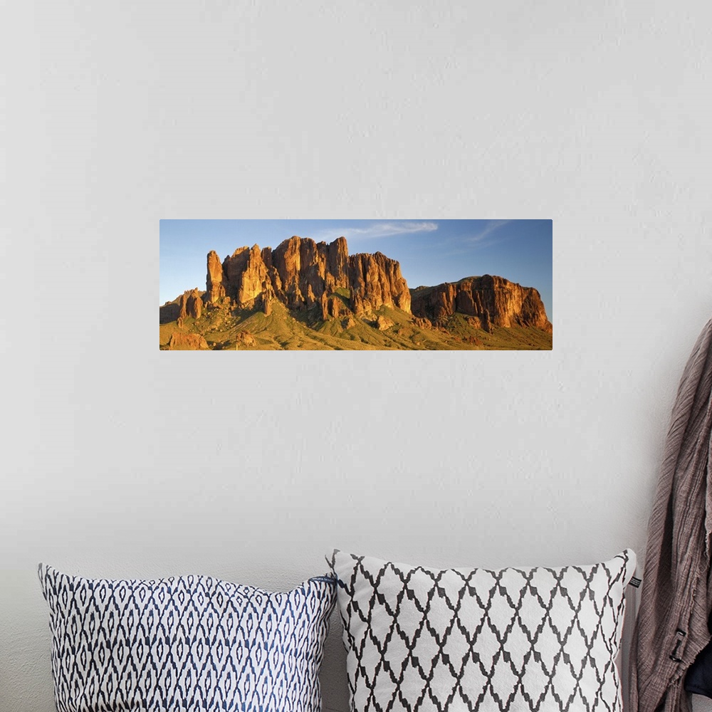 A bohemian room featuring Large Panoramic shot of desert mountains shooting up in the barren flats of Arizona.