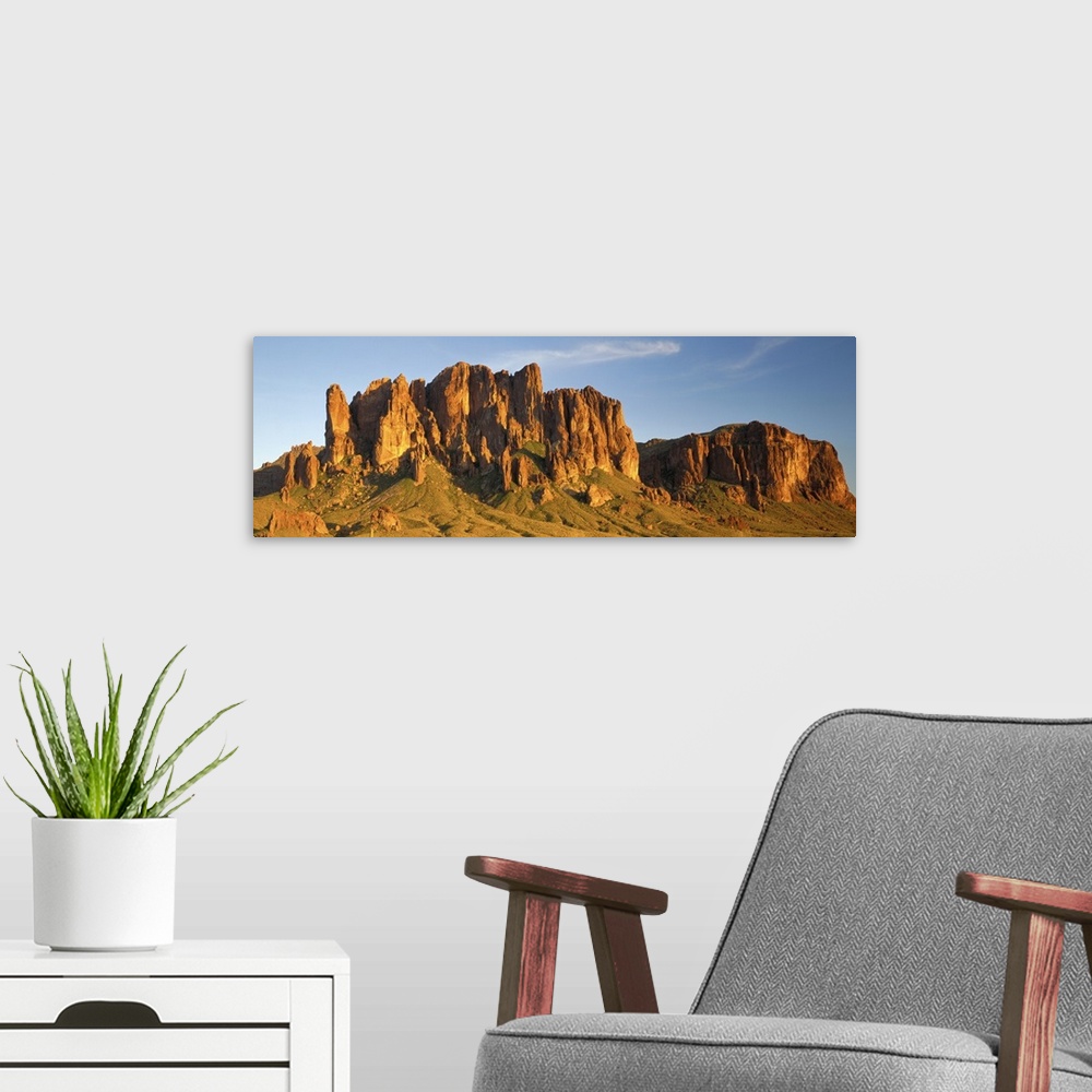 A modern room featuring Large Panoramic shot of desert mountains shooting up in the barren flats of Arizona.