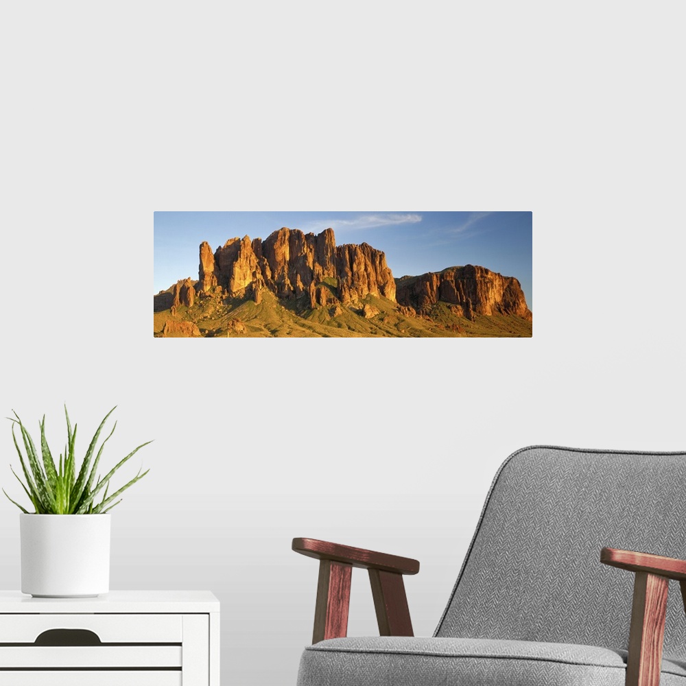 A modern room featuring Large Panoramic shot of desert mountains shooting up in the barren flats of Arizona.