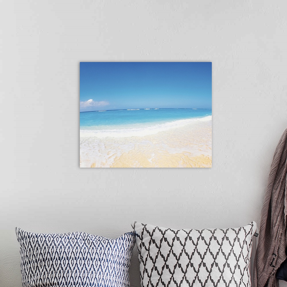 A bohemian room featuring Surf at seashore and blue sky in background