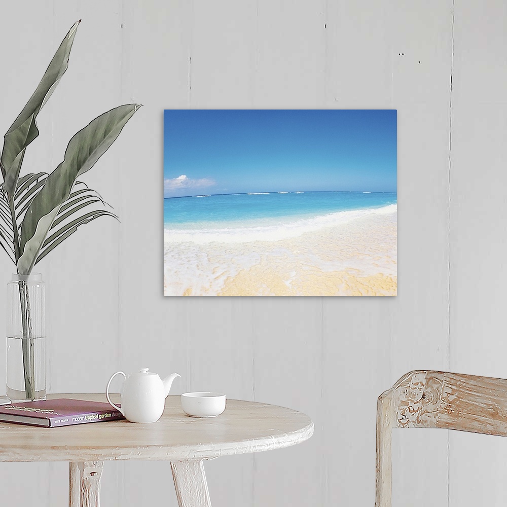 A farmhouse room featuring Surf at seashore and blue sky in background