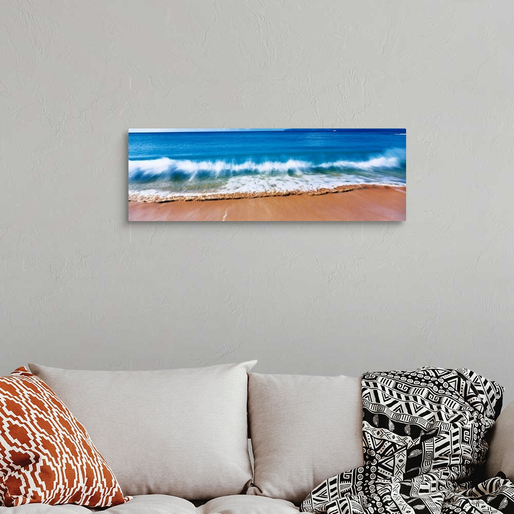 A bohemian room featuring Giant, landscape photograph of a large wave crashing into the sands of Big Makena Beach in Maui, ...