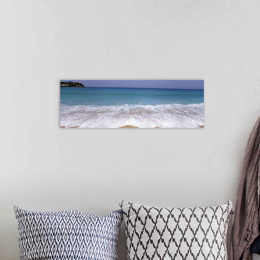 A bohemian room featuring Panoramic image of waves washing ashore from a crystal clear ocean.
