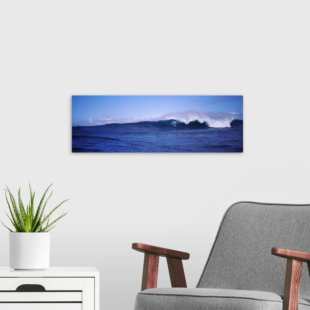A modern room featuring Panoramic image of a surfer riding a large breaking wave.