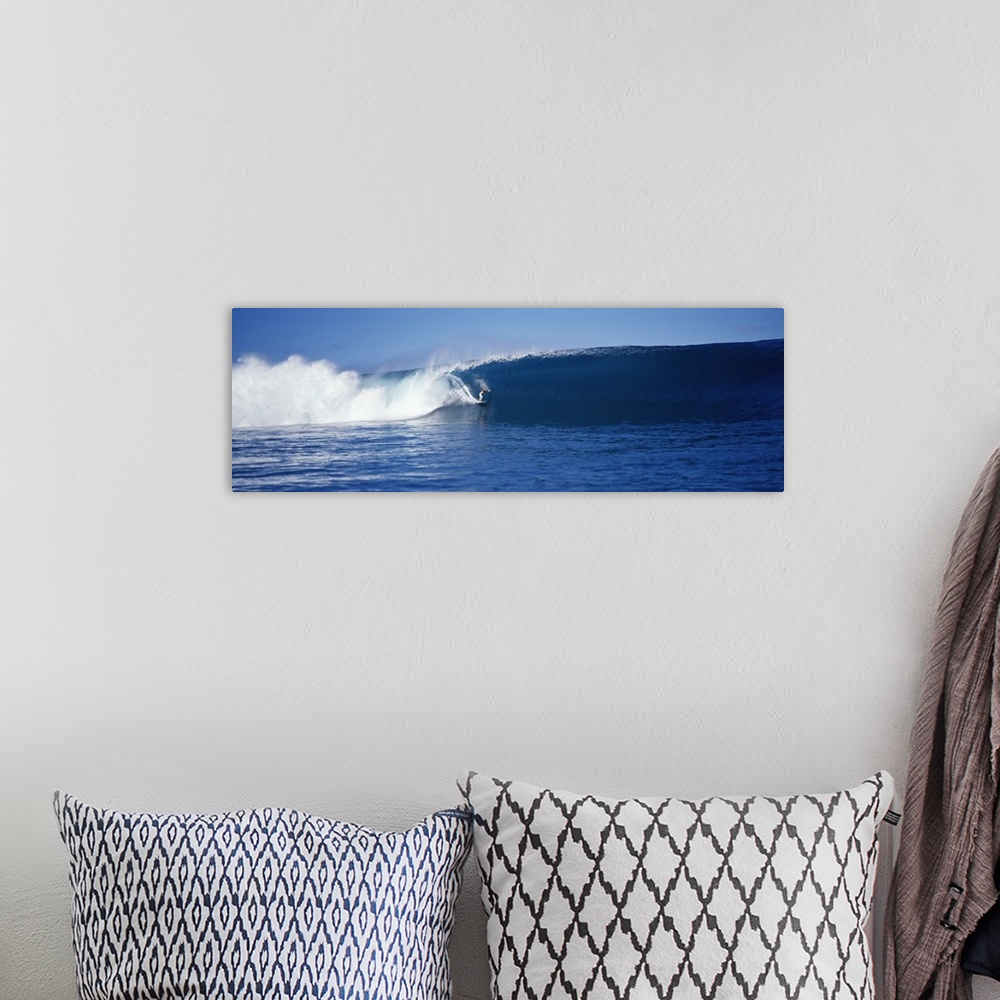 A bohemian room featuring A brave surfer cuts across a plunging wave as it breaks behind his board, almost enclosing him in...