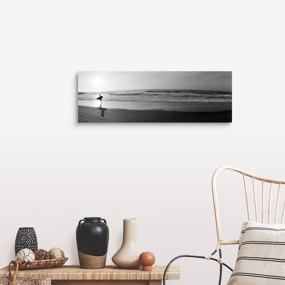A farmhouse room featuring Panoramic photograph of a surfer walking along a sandy beach in San Diego, California.  The tide ...