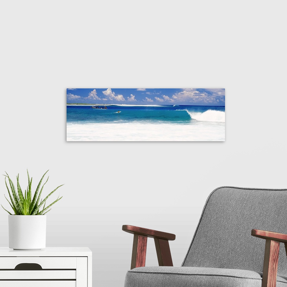 A modern room featuring Surfer surfing in the ocean, Tuamotu Archipelago, Tahiti, French Polynesia