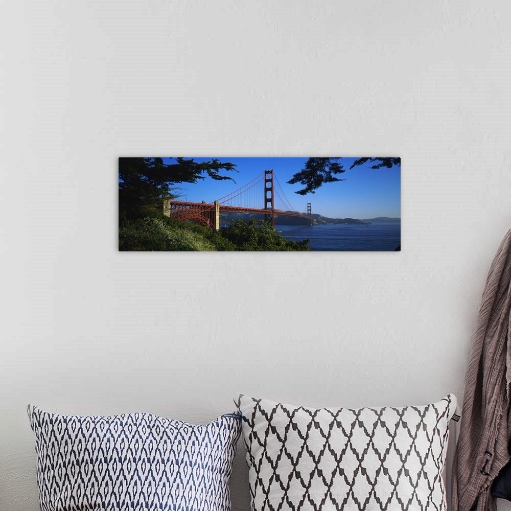 A bohemian room featuring Panoramic photograph on a big canvas looking over a green hillside at the Golden Gate Bridge, ext...