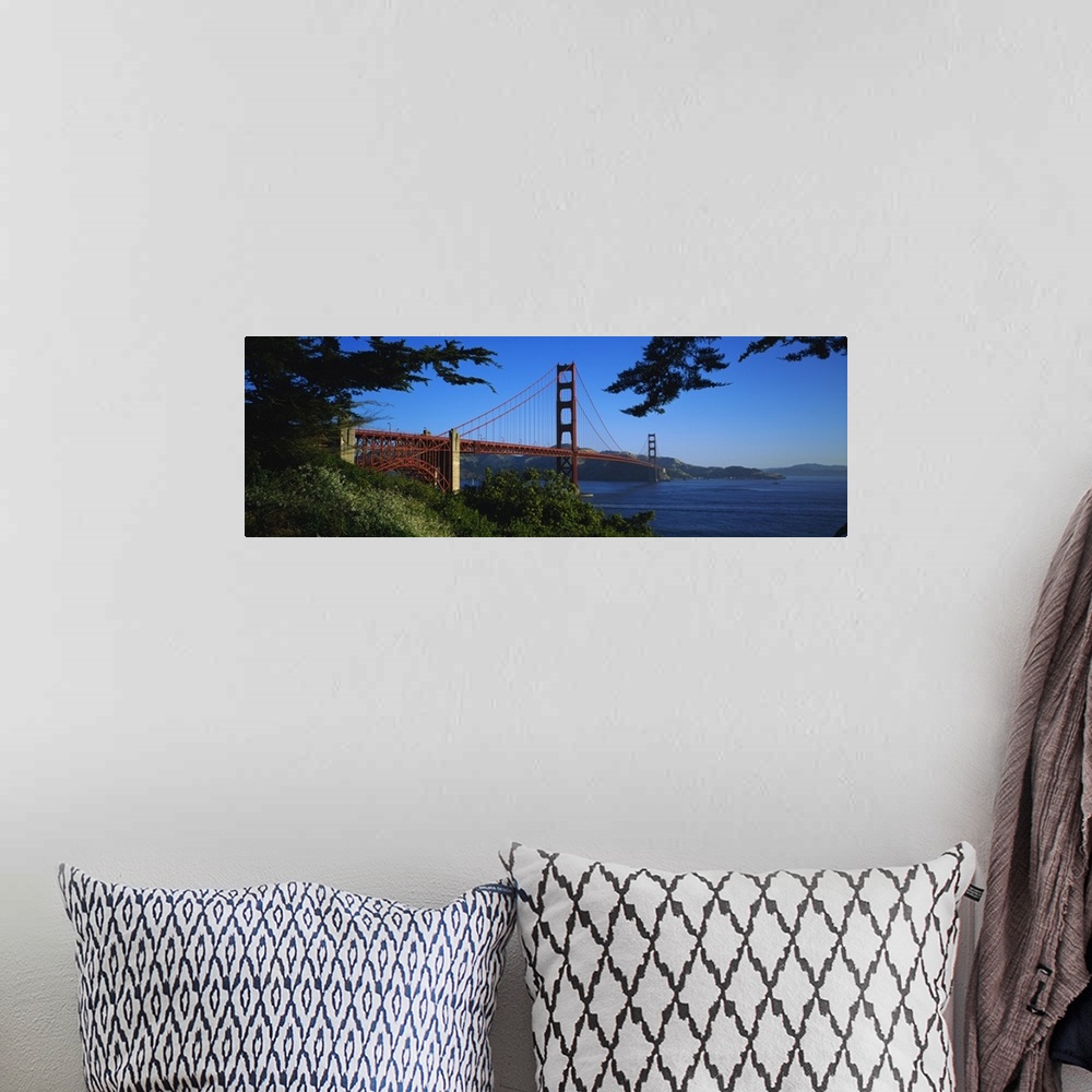 A bohemian room featuring Panoramic photograph on a big canvas looking over a green hillside at the Golden Gate Bridge, ext...
