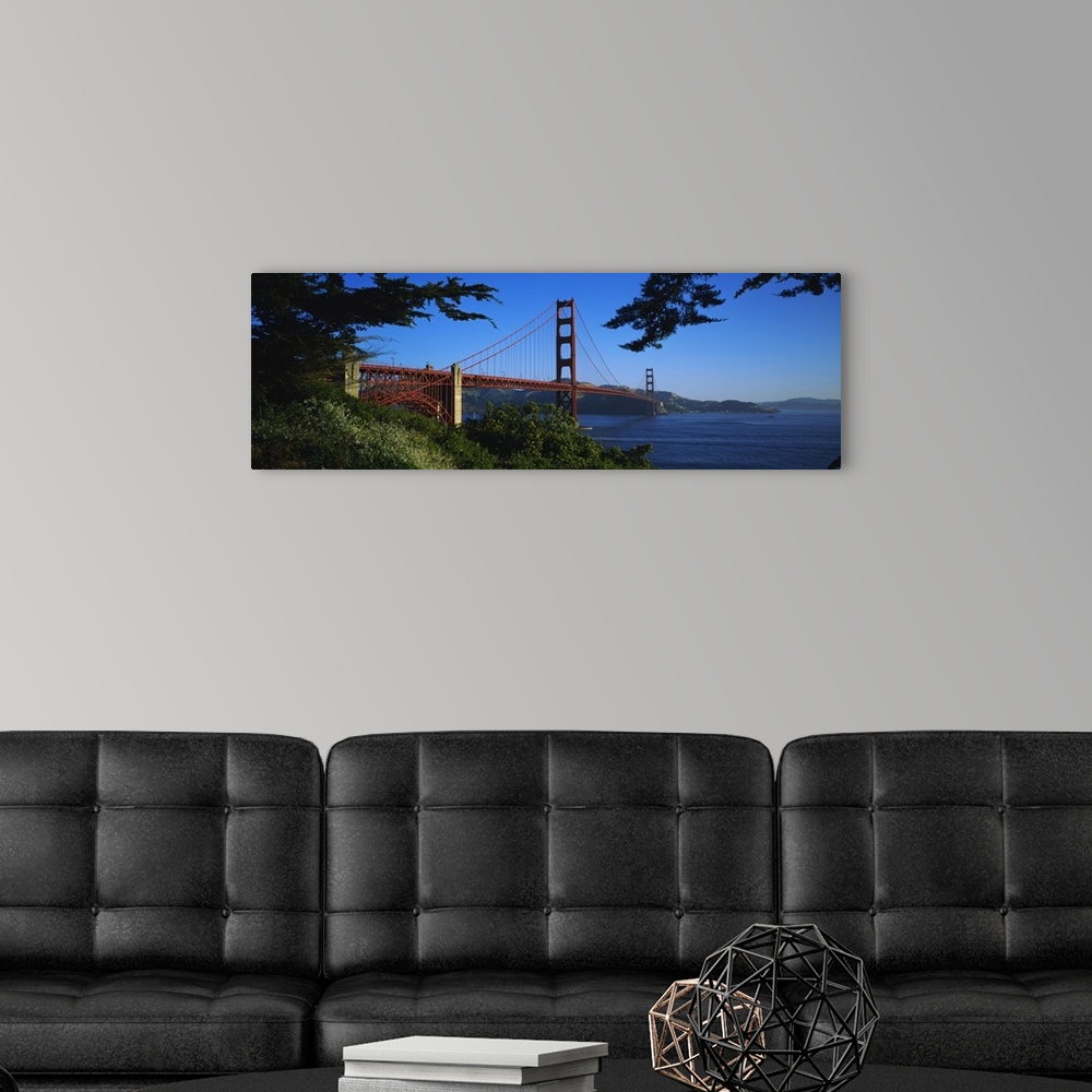A modern room featuring Panoramic photograph on a big canvas looking over a green hillside at the Golden Gate Bridge, ext...