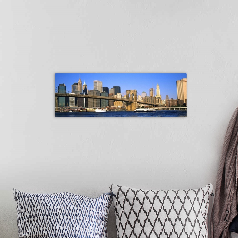 A bohemian room featuring Suspension bridge across a river with skyscrapers in the background, Brooklyn Bridge, East River,...