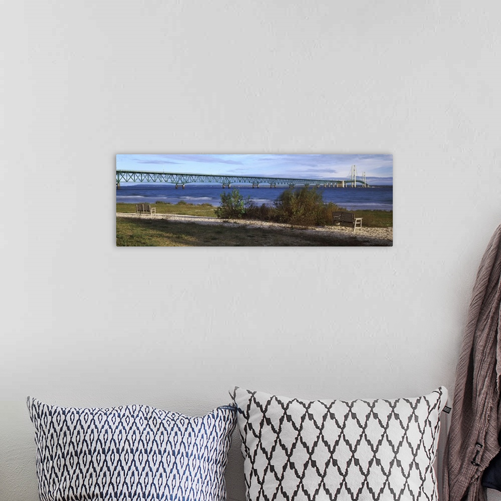 A bohemian room featuring Panoramic photo of the Mackinac Bridge going across the water in Michigan.