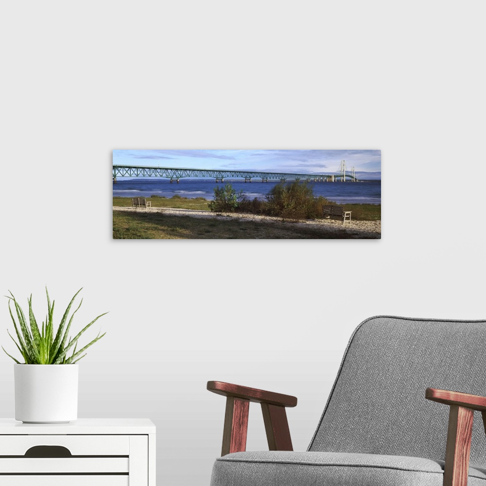 A modern room featuring Panoramic photo of the Mackinac Bridge going across the water in Michigan.