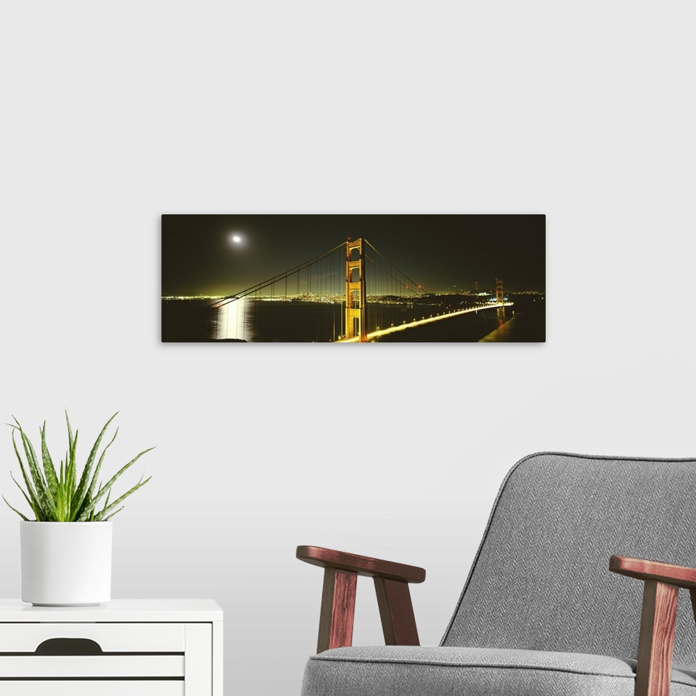 A modern room featuring Giant panoramic photograph of the Golden Gate Bridge at night, the moonlight reflecting in the wa...
