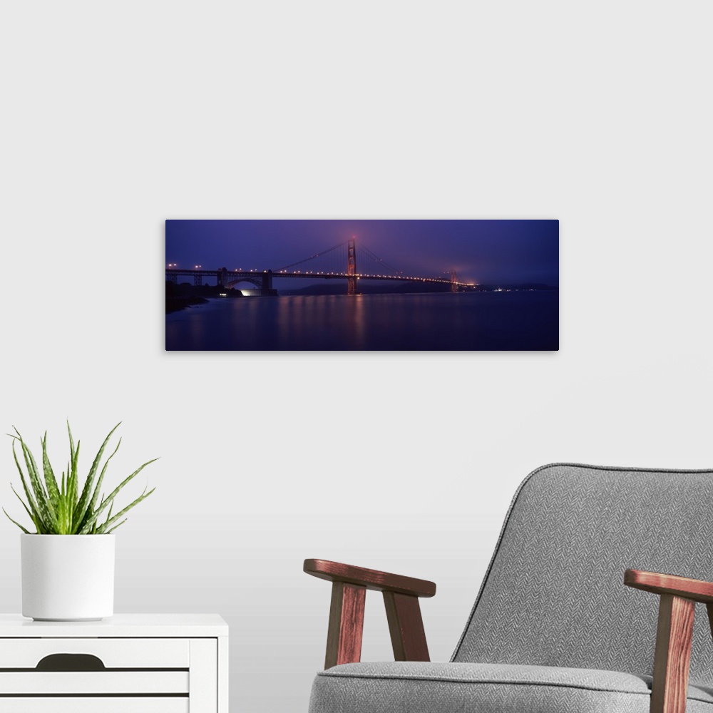 A modern room featuring Suspension bridge lit up at dawn viewed from fishing pier Golden Gate Bridge San Francisco Bay Sa...