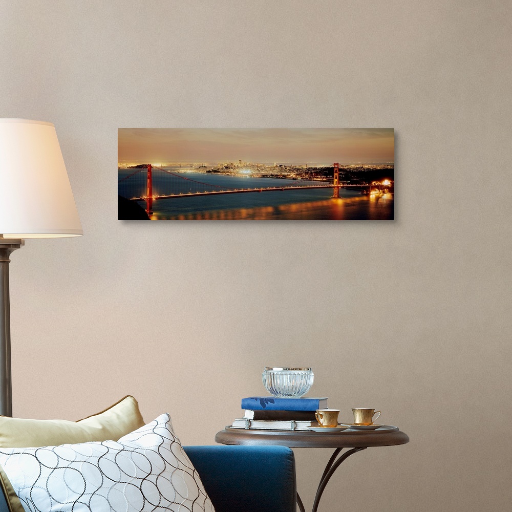 A traditional room featuring Panoramic photograph shows the bright lights of the Golden Gate bridge as they reflect onto the w...
