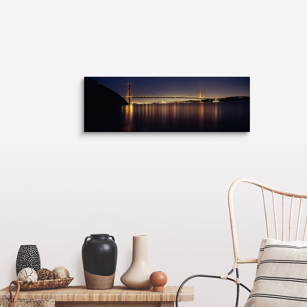 A farmhouse room featuring Wide angle photograph of the Golden Gate Bridge in the distance, lit at night and reflecting over...